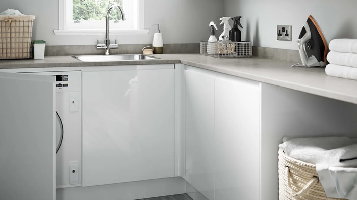 Sink and tap underneath a window in a Madison White Gloss Kitchen