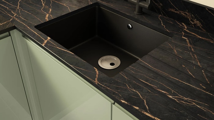 Black sink in a Sofia Reed Green Kitchen